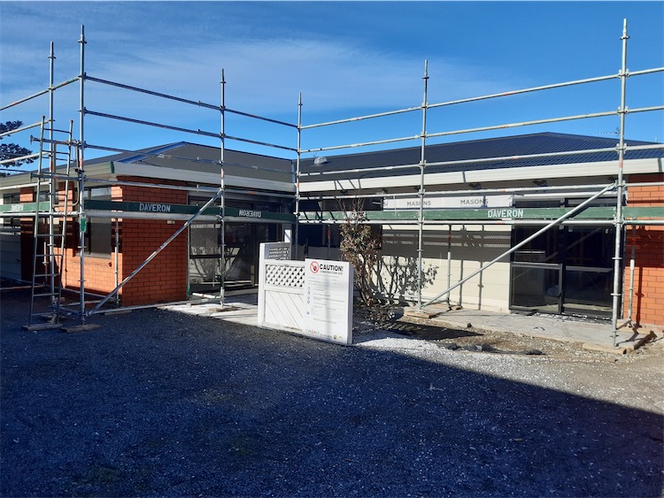 Roofing site set up with safety barriers and protected access