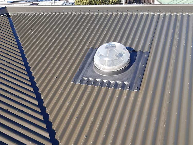 Correctly flashed solar tube penetration on steel roof