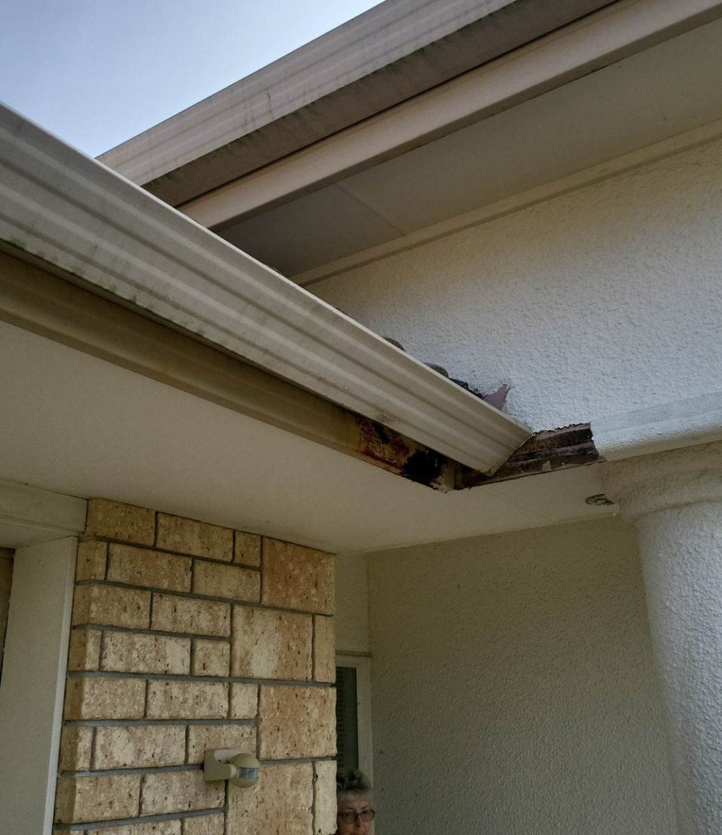 Water damage showing through a fascia and soffit at a wall junction