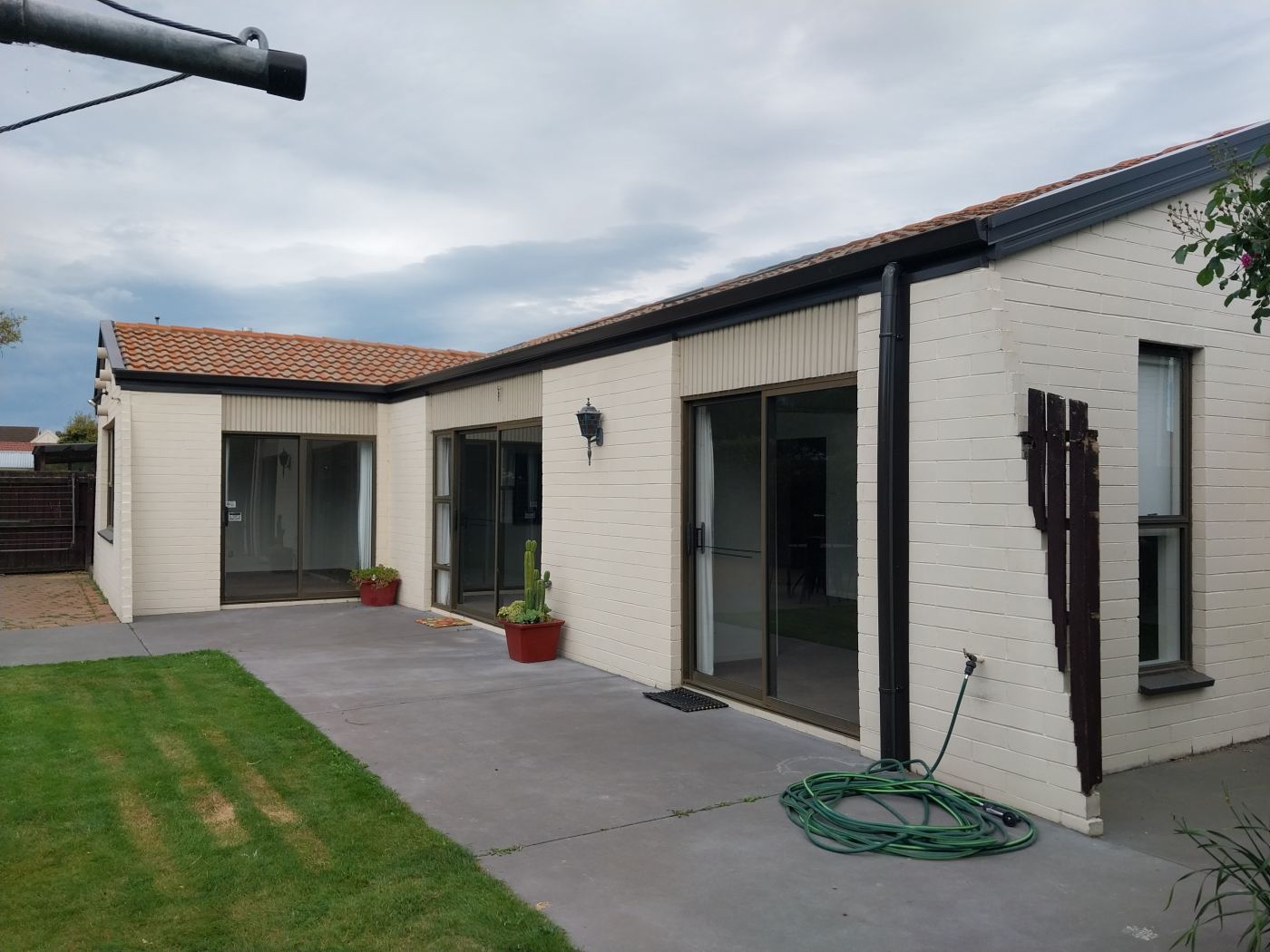 Completed charcoal fascia and gutter across the rear of a block home