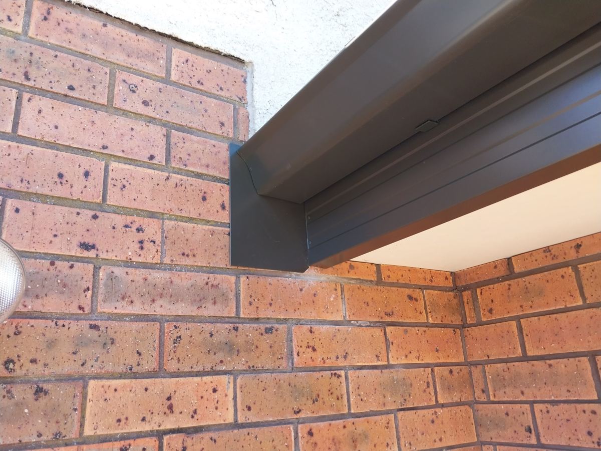 Clean finished fascia and gutter line on a brick home in Dunedin