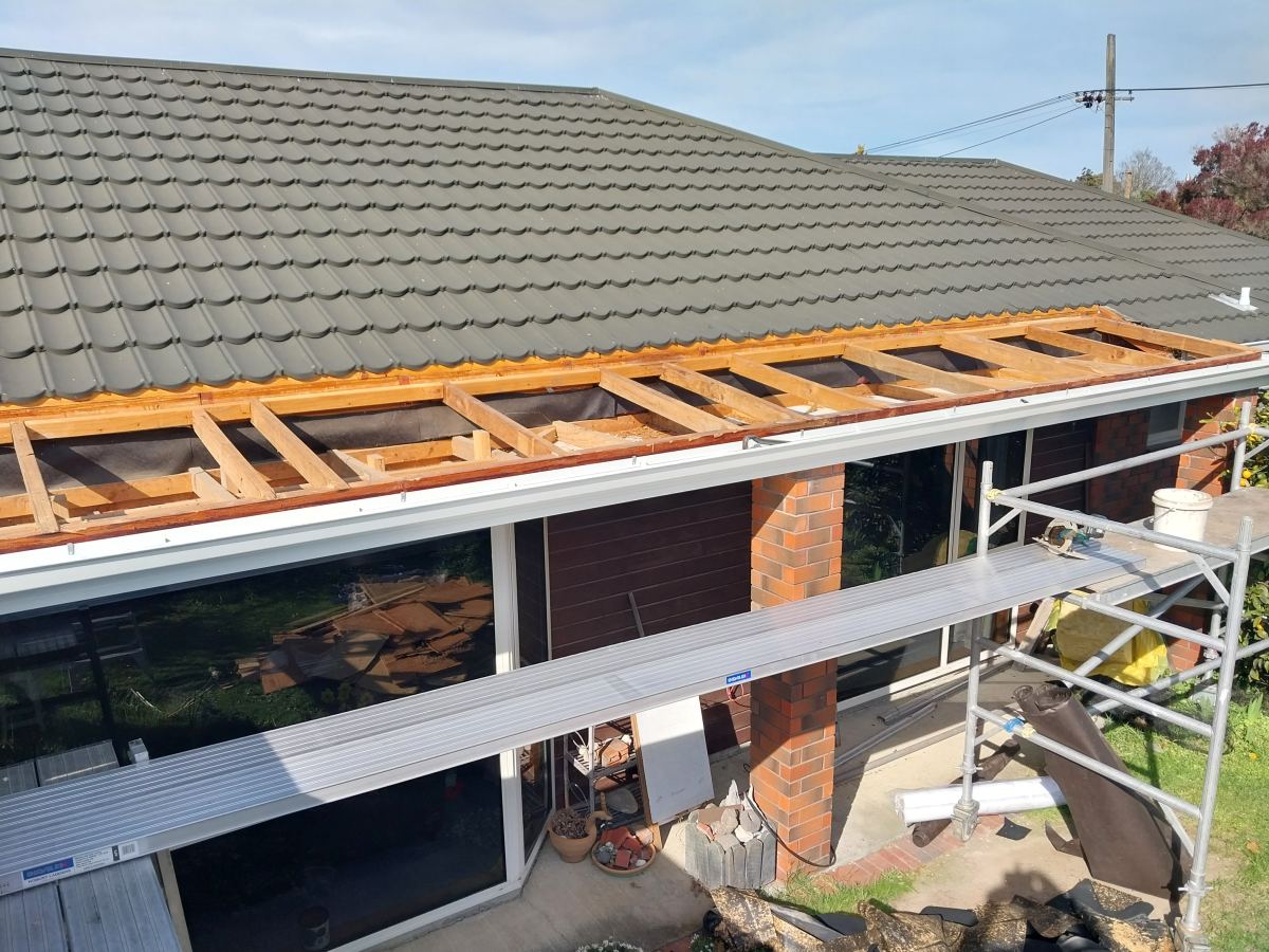 Open roof section with scaffolding in place over the windows below