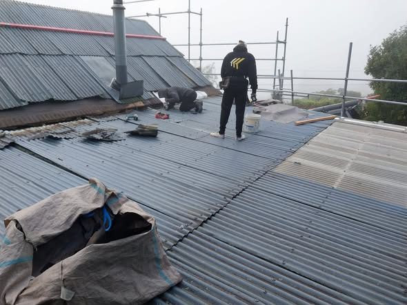 Quality Roofing crew laying new steel at Moenui Bay