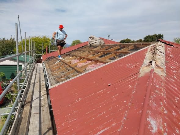 Old roofing stripped in sections during a Burwood reroof